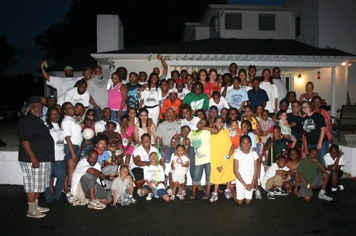 The Tyler-Tinsley family gathered for a group photo at night